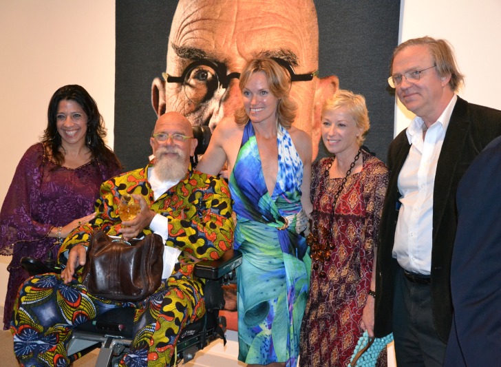 Professor, curator and editor Robert Storr, right, poses with Chuck Close, center, Cindy Sherman, second from right, and others in front of a portrait of Close.