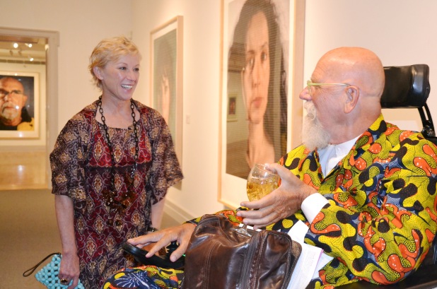 Cindy Sherman and Chuck Close share a moment in front of her portrait (located behind Close and not seen) exhibited at Guild Hall.