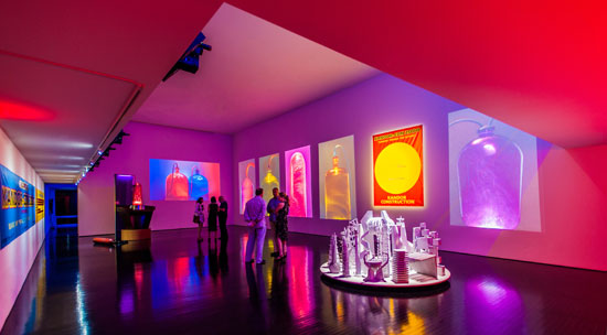 One of the rooms of the exhibition that includes video projections, models, posters and Kandor 17. Photo: Lovis Dengler.
