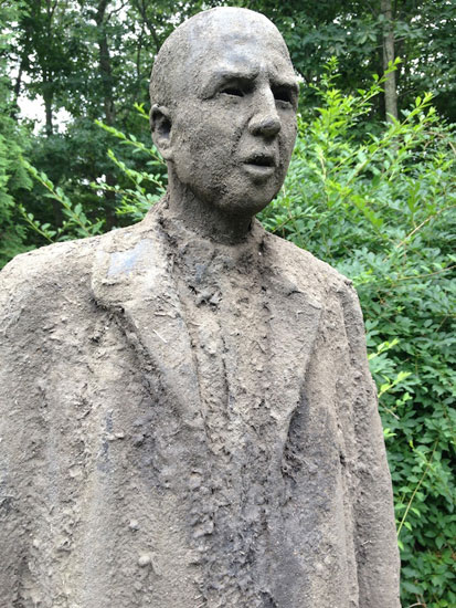 Detail of "Dirt Man With Wolf" by James Croak. Cast dirt. Photo by Annette Hinkle. 