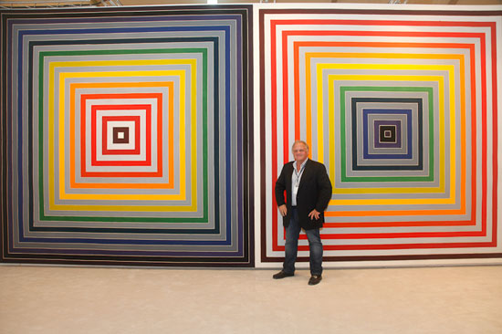 Mark Borghi standing in front of Frank Stella Artwork. Artwork: "Le Reve de d'Alembert" by Frank Stella, 1974. Synthetic polymer paint on canvas, 11 feet x 7 1/2 inches x 23 feet x 6 3/4 inches. Art Miami 2014. Photo by Kathy Zeiger. 