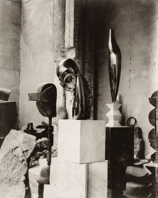 "View of the studio: Plato, Mademoiselle Pogany II, and Golden Bird" by Constantin Brancusi, c. 1920. Gelatin silver print, 11 3/4 × 9 1/2 inches. Private collection. © 2014 Artists Rights Society (ARS), New York/ADAGP, Paris. Courtesy Gagosian Gallery. 