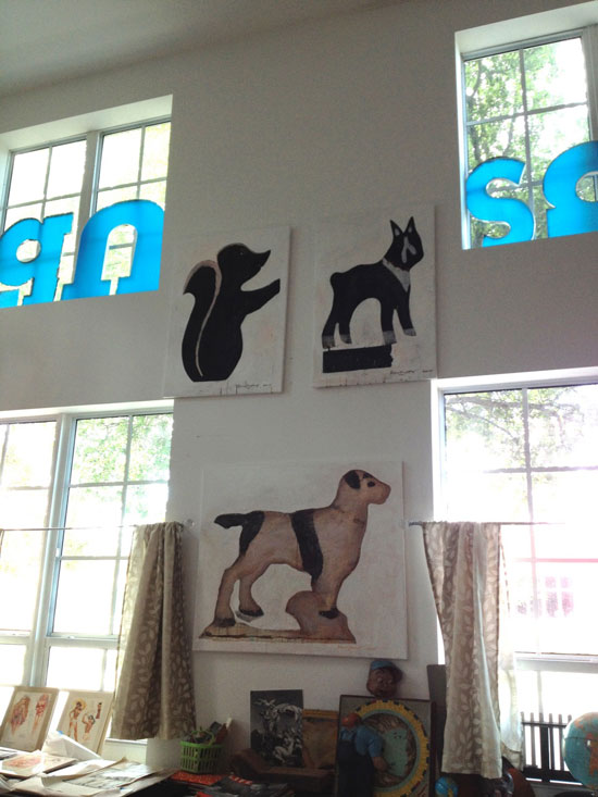Bruce Helander's studio wall of dog folk art paintings. Photo by Sandra Hale Schulman. 