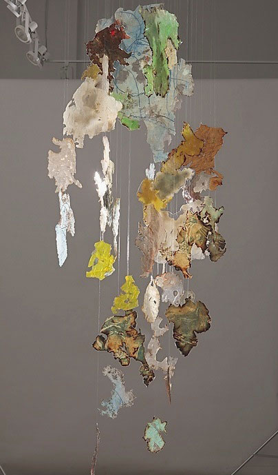 "Indefinite Integral" by Mira Lehr, 2011. Woodblock on burned Japanese paper, stainless steel, resin, 32 x 98 x 32 inches. 