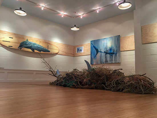Fishnet Shark installation with surfboard and painting by Dalton Portella. 