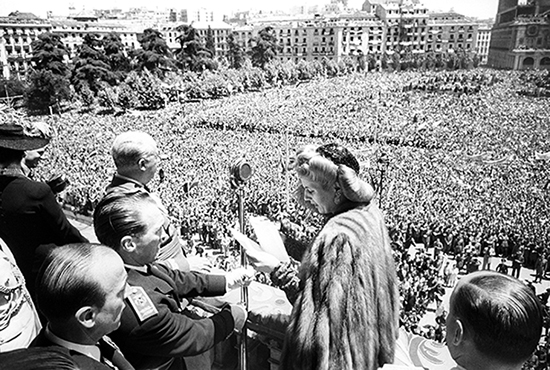 Eva Duarte de Peron, wife of the then president of Argentina, Juan Peron, greets the crowd from the balcony of the Royal Palace of Madrid during the Franco regime. Evita traveled to Spain with tons of wheat helping mitigate famine after the war. Courtesy Agencia EFE.