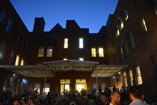 Dusk creeps in as crowds thicken in the MoMA PS 1 courtyard at the Preview of the NY Art Book Fair. Photo by Cristina Schreil.