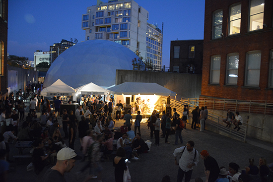 Visitors crowd MoMA PS1's courtyard at Thursday night's preview. Photo by Cristina Schreil. 