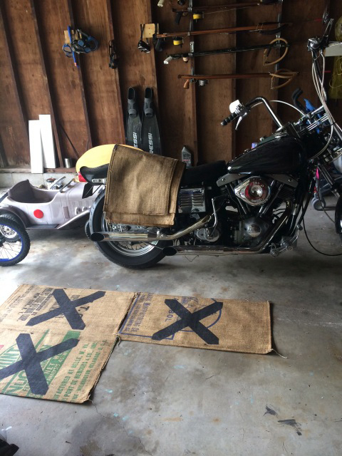 Olivier Mosset's burlap bags with printed X and a Shovelhead motorcycle shipped from Arizona to ride on the North Fork that are part of the exhibition "MOMMA" at ART gallery at Rothman's Department Store.  