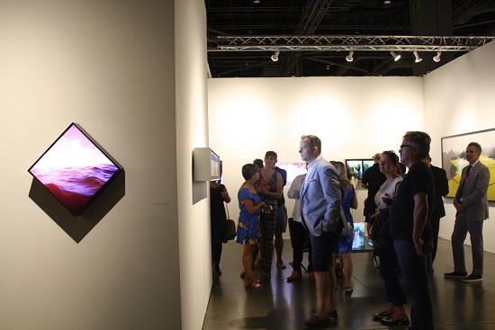 Examining works by Yorgo Alexopoulos at Bryce Wolkowitz Gallery of New York at Seattle Art Fair. Photo by Amber Cortes.