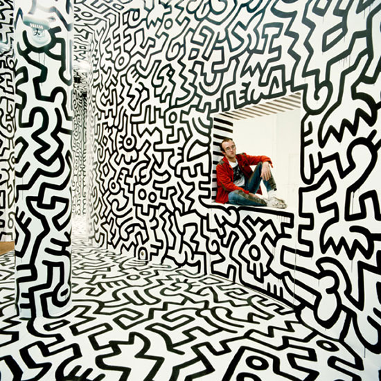 "Haring in Pop Shop (sit in window)" by Tseng Kwong Chi, New York, 1986. Digital chromogenic print, 30 x 30 inches. Courtesy of Eric Firestone Gallery.