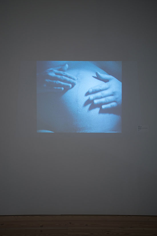 installation view of "Antepartum" by Mary Kelly, 1973. Super 8 film transferred to video, black-and-white, silent; 1:30 min. looped. Whitney Museum of American Art, New York; gift of the artist.