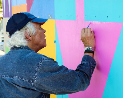 Ron Burkhardt paints his "WEST PALM" mural on location in West Palm Beach. Courtesy of the artist.