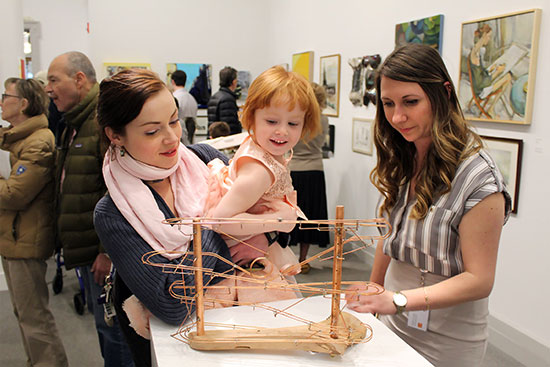 Krysta Lamiroult with her daughter Danika and Kristen curie playing with Augie Hoffman's "Drop In." Photo by Tom Kochie.