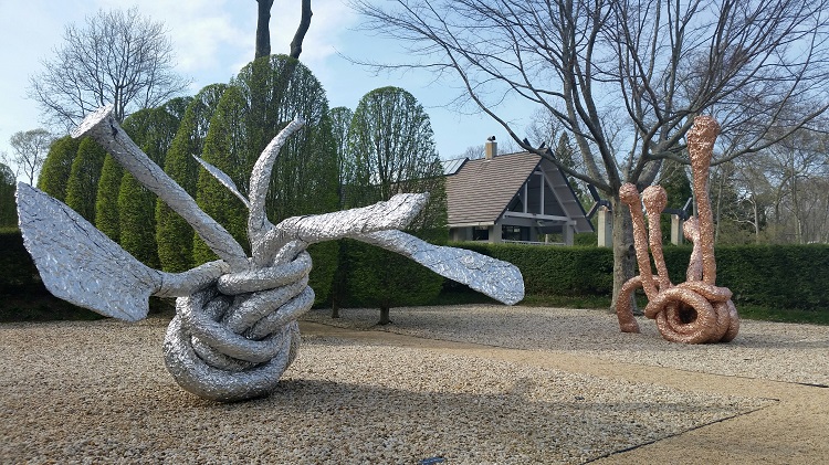 "FROSTYDICKFANTASY," 2008, and "PINEAPPLESURPRISE," 2010, by John Chamberlain installed at LongHouse Reserve. Colored aluminum foil. Sculptures on loan from Estate of John Chamberlain and Gagosian Gallery. Photo by Pat Rogers.