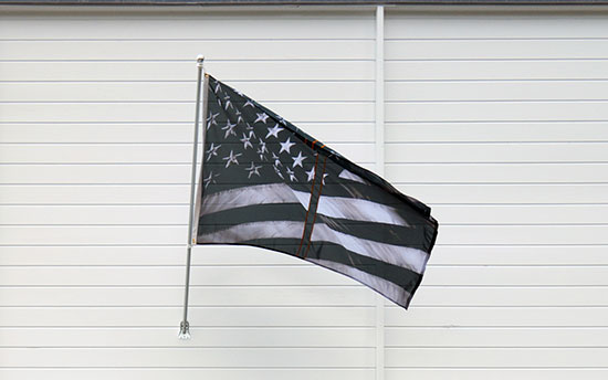 "Untitled (Dividing Time)" by Robert Longo, 2017, installed at the Aldrich Contemporary Art Museum as part of Creative Time's "Pledges of Allegiance" public art project. Polyester flag, fabric and mixed media. Photo by Paul Hodara.