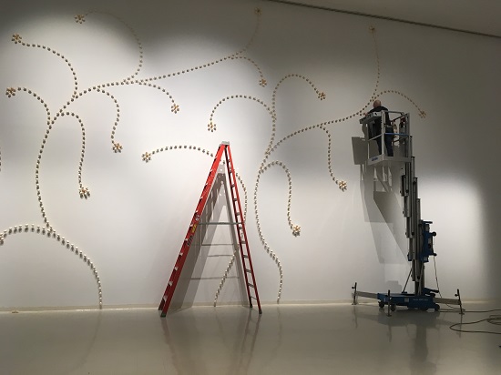 Charley Friedman installing "Garden" at the Paul W. Zuccaire Gallery, Stony Brook University. Photo courtesy Stony Brook University.
