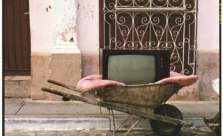 "TV Wheelbarrow" by Zoe Leonard, 2001. Dye transfer print, 20 × 16 inches. Collection of the New York Public Library; Funds from the Estate of Leroy A. Moses, 2005. Courtesy The Whitney Museum of American Art.