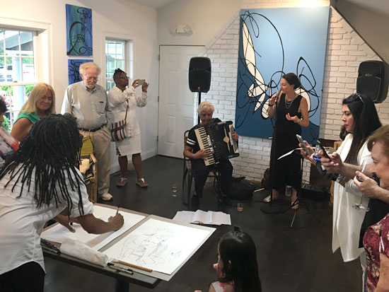 Artist Robin D Williams creates a blind contour drawing of the performance during the Opening Reception of “Syncopation” at William Ris Gallery. Courtesy William Ris Gallery.