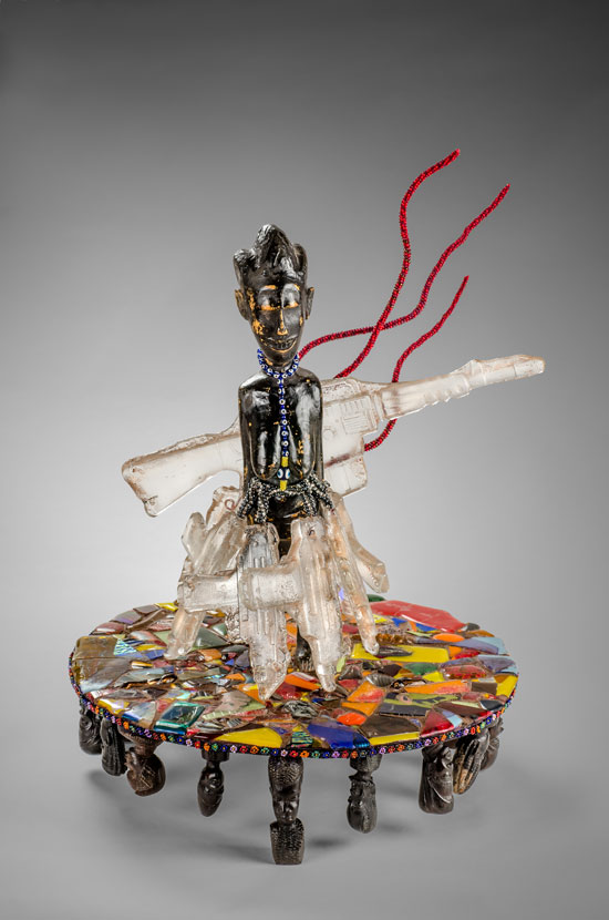 "War Woman II" by Joyce J. Scott, 2014. African sculpture, fused and painted mosaic glass, glass/plastic beads, wire, thread, metal keys and cast glass guns, 25 x 18 x 18 inches. Courtesy the artist and Peter Blum Gallery, New York.