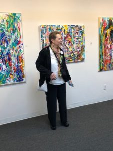 Photograph of artist, Karen L. Kirshner in front of her artwork.