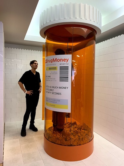 “Drug Money” by Cj Hendry, 2019. Powder coated stainless steel, tinted ½” tempered safety glass, EPS hard coated foam, 102 x 42 inches. Curated by John Zinonos. Photo by Joanna Gmuender.