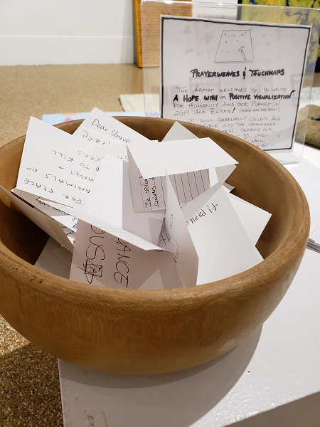 A bowl of prayers or intentions left by visitors in Darlene Charneco's pop up studio at Southampton Arts Center. Photo by Pat Rogers.