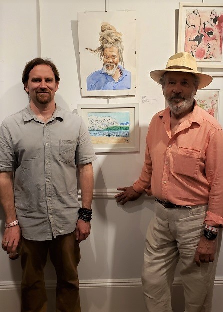 Artists Lutha Leahy-Miller and Peter Gumpel stands besides their artwork. Top: "Lü†hårt - Oceania 41919" by Leahy-Miller. Ink, brush and pen on paper. Bottom: Gumpel's watercolor, "Smile." Photo: Pat Rogers. 